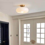 Amber glass flush mount light showing the copper canopy and short stem