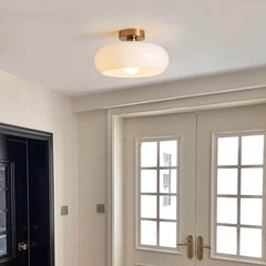 Amber glass flush mount light showing the copper canopy and short stem