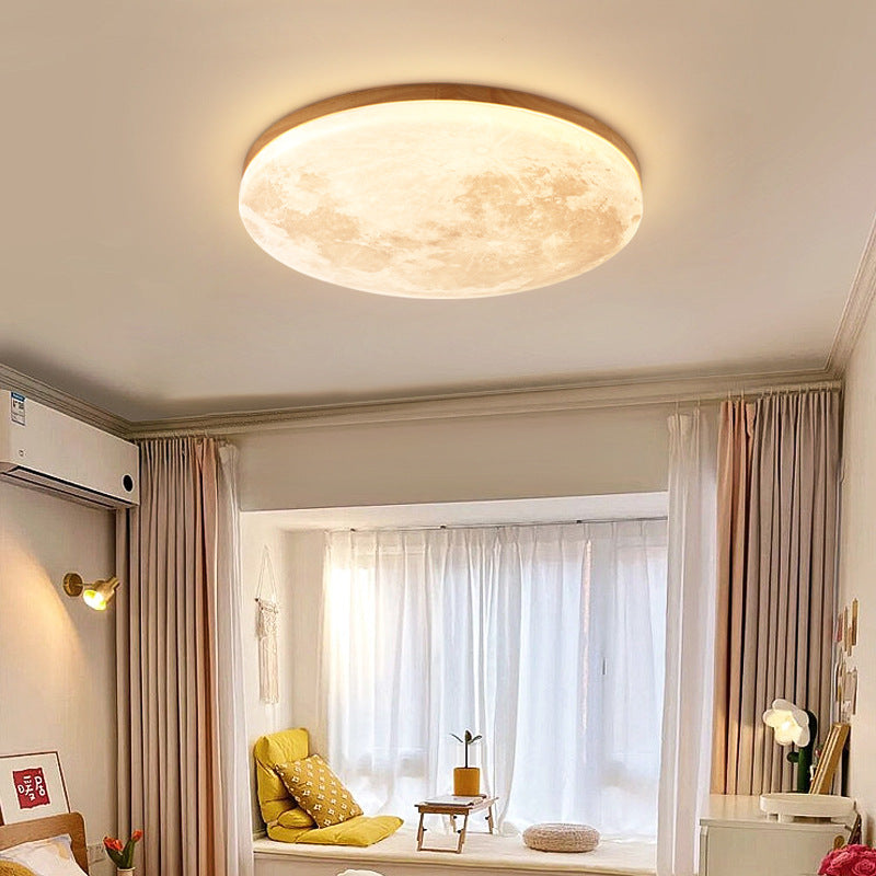 Angled view of the wood-rimmed round moon flush mount ceiling light