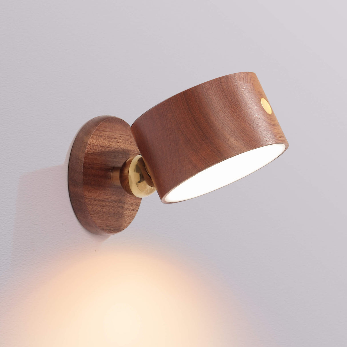 Beech wooden cordless wall sconce lit against a pale background