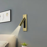 Warm reading light glow beside pillows and a headboard at night