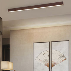 Natural wood tone flush mount bar light over neutral decor
