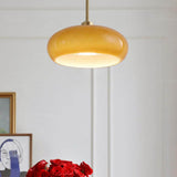 Amber glass pendant light on a long copper suspension rod