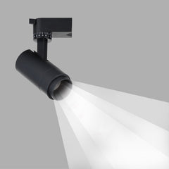 Black tubular spotlight head with graduated tilt dial casting a beam
