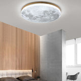 Moon round LED flush mount ceiling light glowing warmly in a hallway