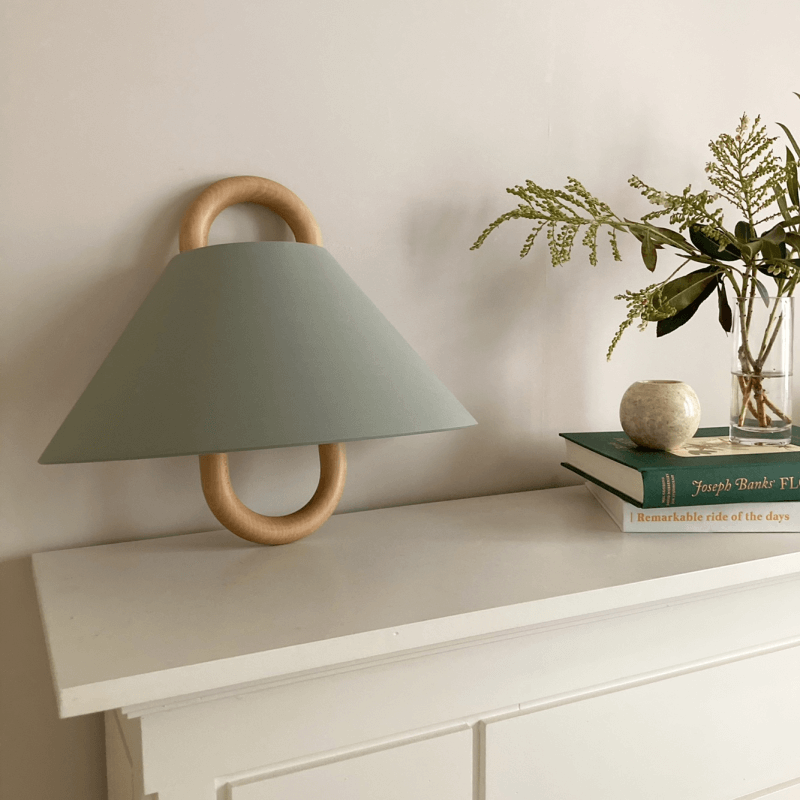 Fabric wall sconce mounted on a wall and switched on