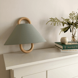 Fabric wall sconce mounted on a wall and switched on