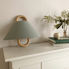 Fabric wall sconce mounted on a wall and switched on