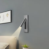 Reading sconce spotlight tilted for over-shoulder reading in bed