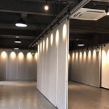 White track spotlights in a two-storey white boutique interior