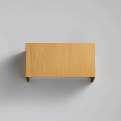Warm gold aluminum sconce casting upward and downward light beams