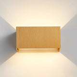 Coffee gold up and down wall sconce mounted on a neutral wall