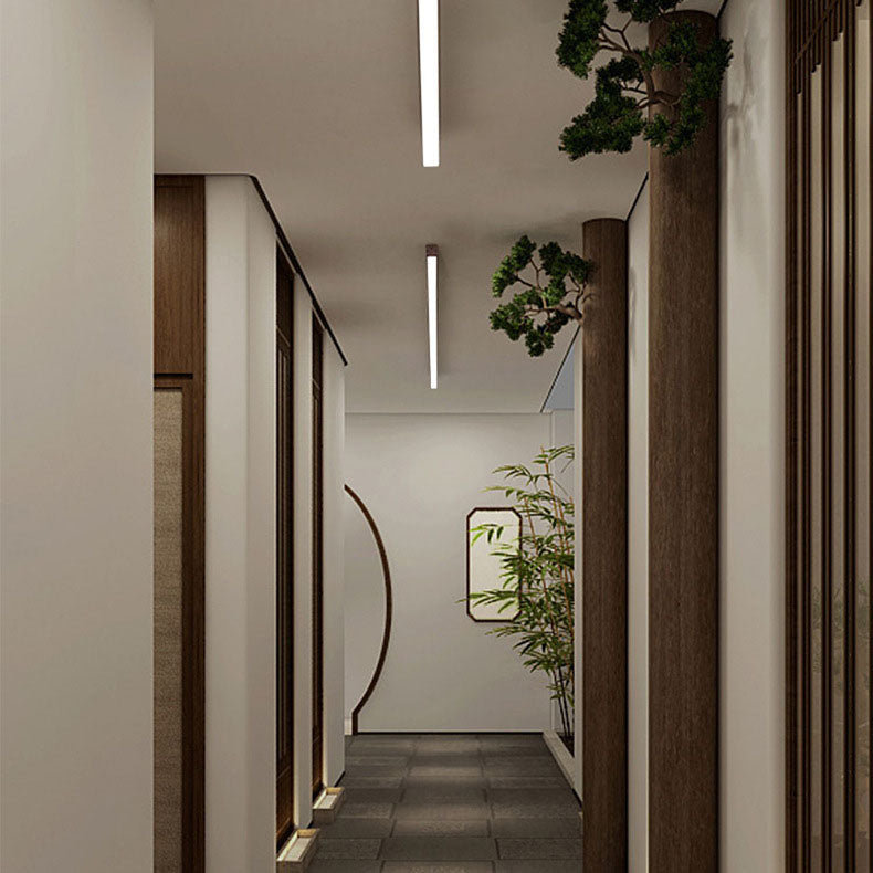 Wood grain LED linear light seen against a soft grey ceiling