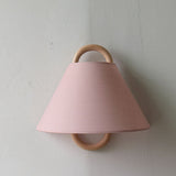 Detail of the fabric shade pleats and the wood mount
