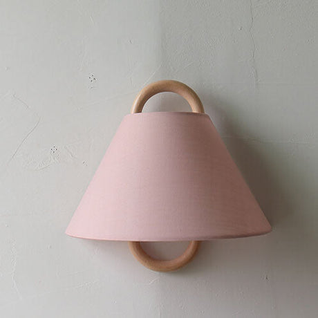 Detail of the fabric shade pleats and the wood mount