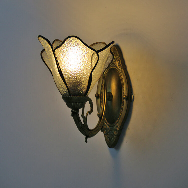 Warm lit petal sconce highlighting the streaked art glass tones