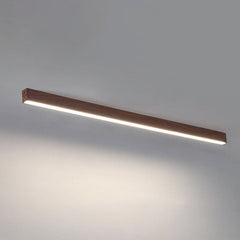 Low profile linear bar light hugging a white plaster ceiling