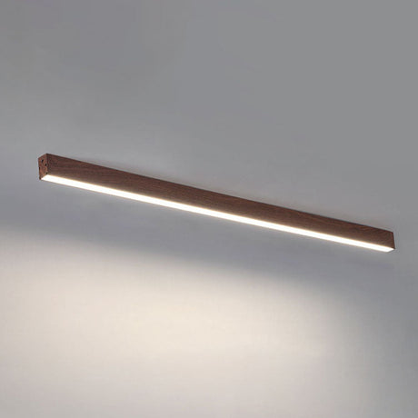 Low profile linear bar light hugging a white plaster ceiling