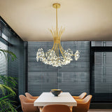 Gold dandelion chandelier over a dining table beside slatted window blinds