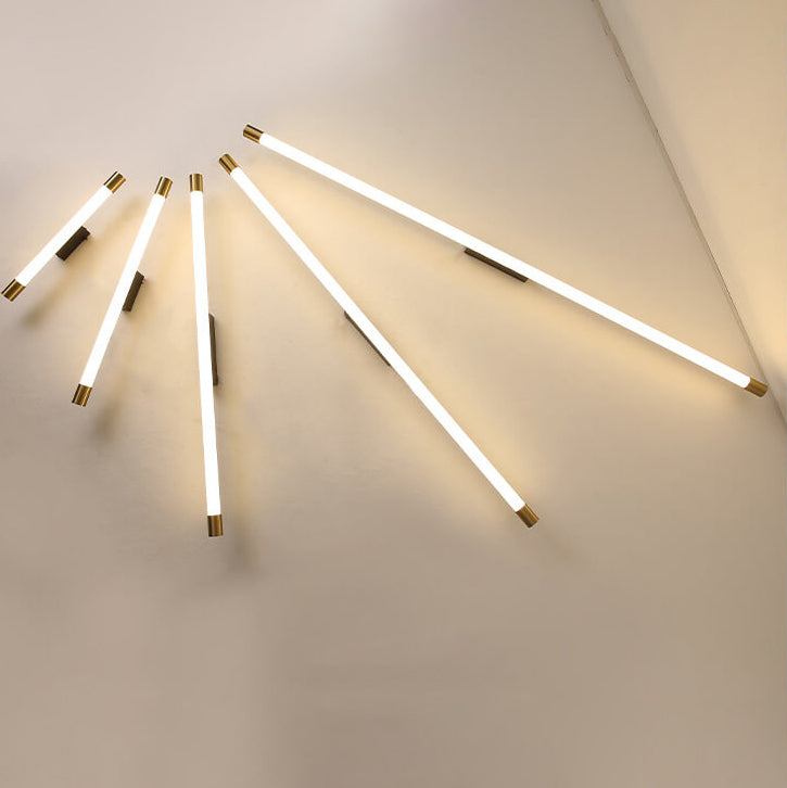 Lit LED tube sconce casting an even warm glow along its length