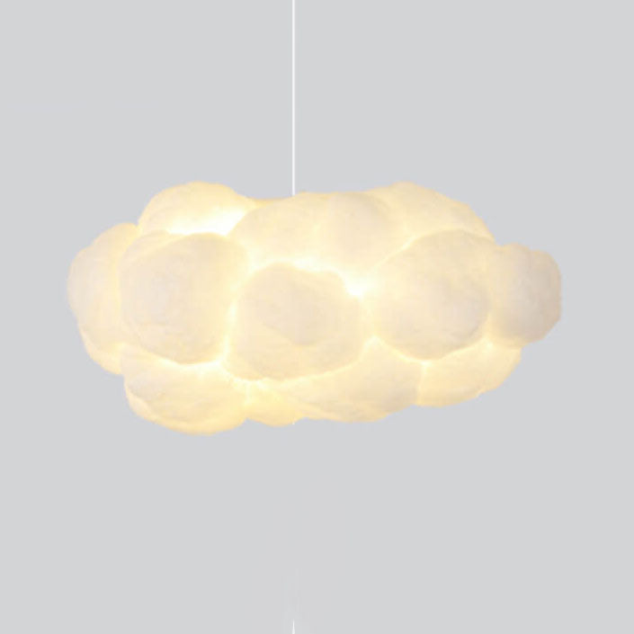 Cloud pendant light casting a warm ambient glow on a grey backdrop