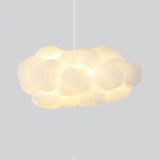 Cloud pendant light casting a warm ambient glow on a grey backdrop
