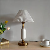 Angled view of the pleated shade lamp and brass hardware fittings