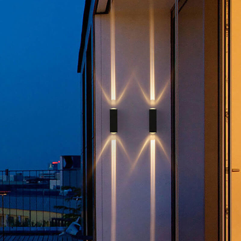 Outdoor wall sconce with twin warm beams against a night city skyline