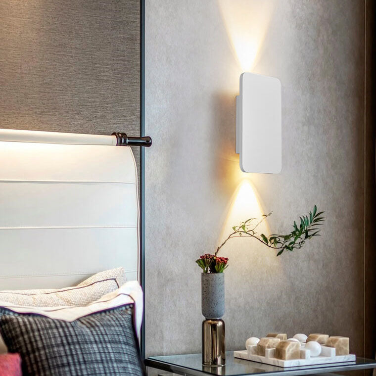 Gold rectangular wall sconce detail on a light background