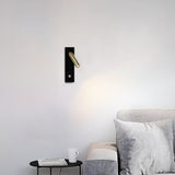 Nickel finish reading wall sconce mounted beside a headboard