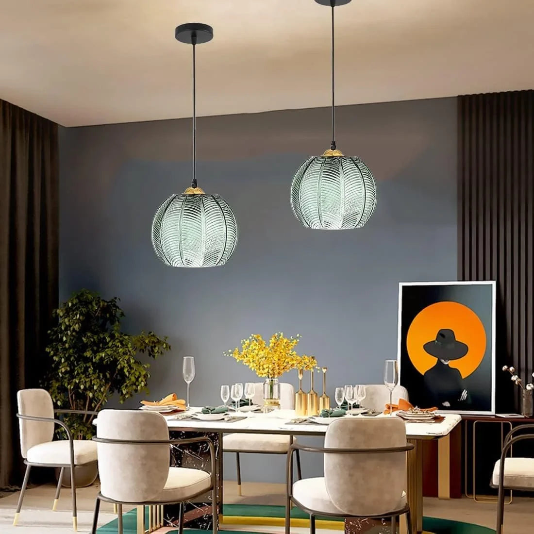 Green glass palm leaf pendant as decorative lighting over a styled dining room table