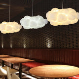 Cloud pendant lights over booth seating against a woven restaurant wall