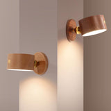 Beech and walnut wall sconce finishes displayed side by side