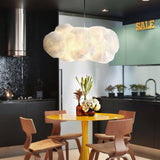 White cloud pendant hanging above a yellow kitchen dining table
