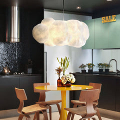 White cloud pendant hanging above a yellow kitchen dining table
