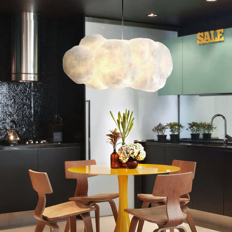White cloud pendant hanging above a yellow kitchen dining table