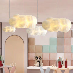 White cloud pendant lights glowing above a pastel padded children's playroom wall