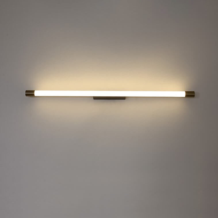 Modern LED wall sconce shown at an angle with brass caps and black backplate