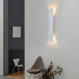 White LED outdoor wall sconce casting soft up and down light on a wall