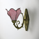 Petal wall sconce displayed beside its packaging