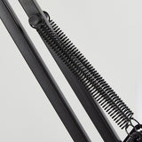 Clip-on desk lamp positioned low over a work surface