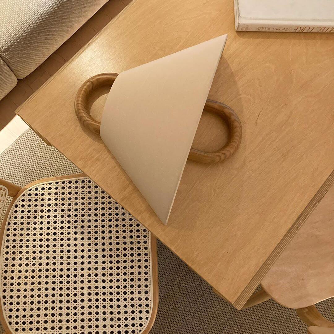Fabric wall sconce with the bulb glowing through the shade