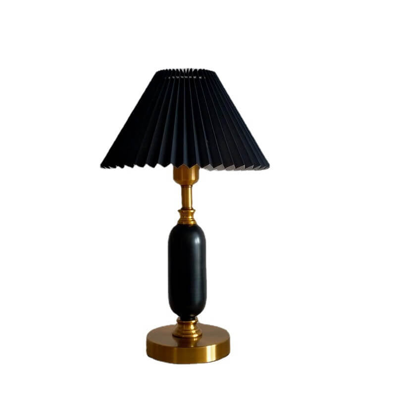 Pleated shade table lamp lit to show its warm even glow