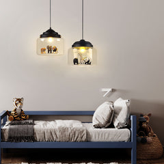 Two black-capped animal pendant lights above a blue kids bed with plush toys