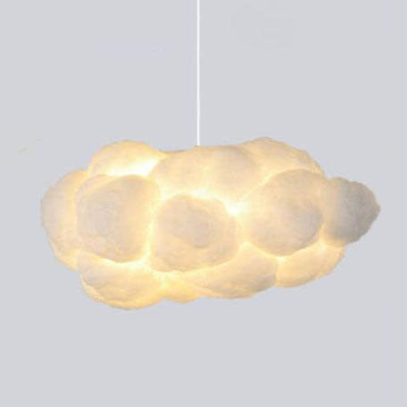 White cloud pendant light illuminated against a plain grey studio wall