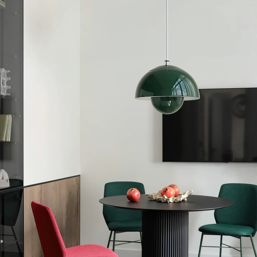 Green bud shaped metal pendant light against a light neutral wall