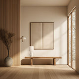 Small white ceramic table lamp on a wooden bench in a minimalist hallway