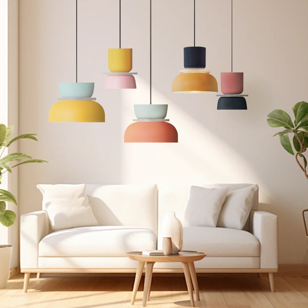 Five pendant colourways grouped above a sofa in a white living room