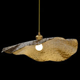 Underside of a wide gold lotus leaf pendant with exposed bulb