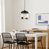 Glass pendant light over white dining table, zebra, bear and panda figures under black cap